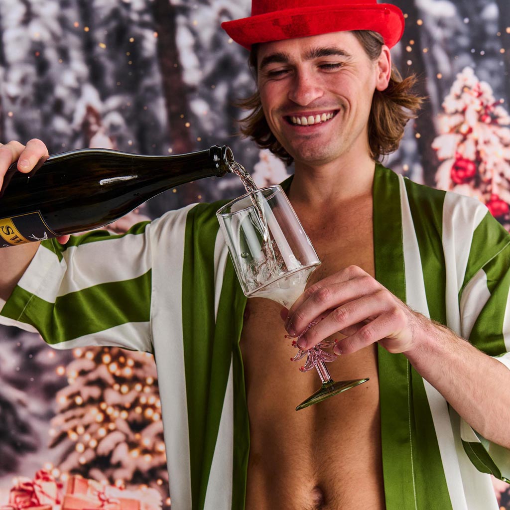 The image shows a luxurious robe made from eco-friendly satin fabric. The robe features a stylish moss green color with subtle stripe patterns running vertically. It has a relaxed fit with a belt at the waist for adjustable comfort. The fabric appears smooth and glossy, reflecting light softly, which enhances its elegant appearance. The robe is displayed on a plain background, allowing the details and texture of the fabric to stand out.