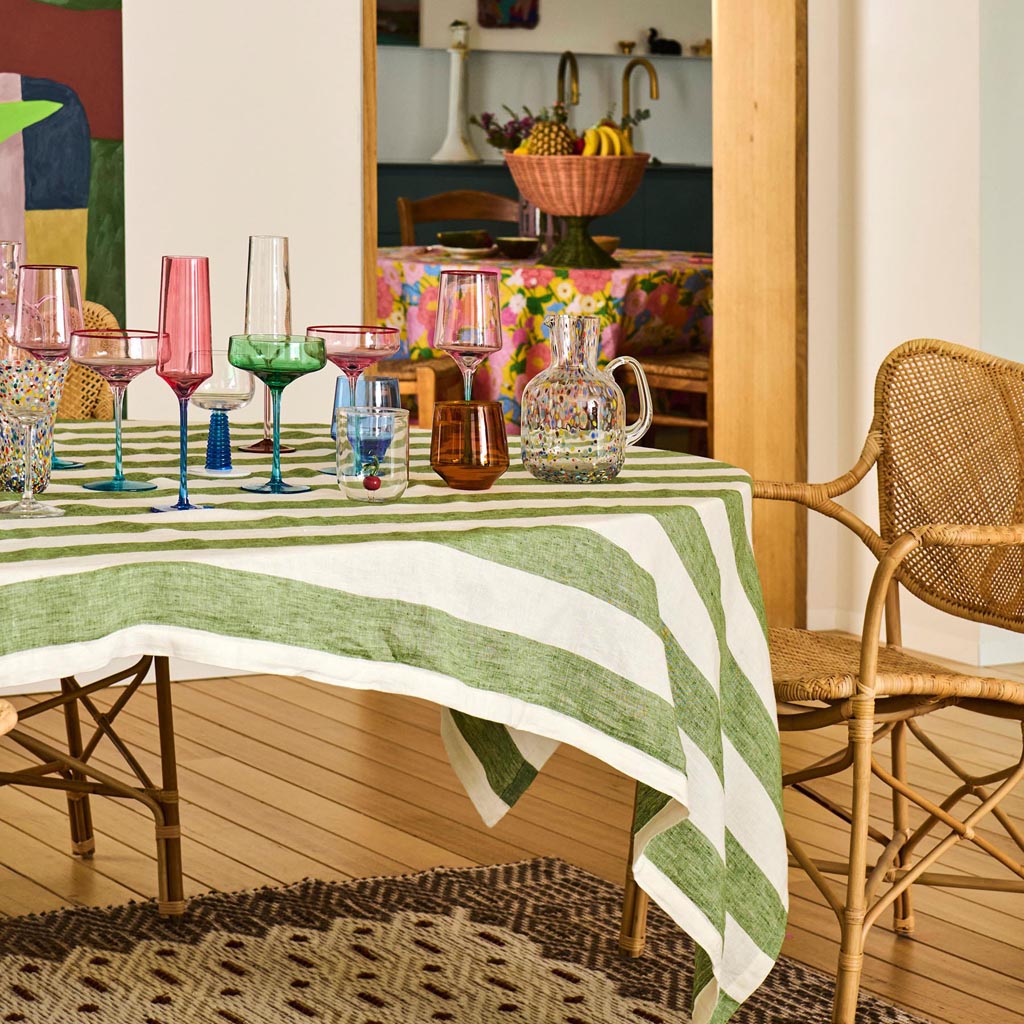 The image shows a set of two margarita glasses from Kip & Co, named "Pistachio Crush." The glasses have a unique and stylish design, featuring a textured surface with a pistachio green hue. The stems of the glasses are elegantly shaped, adding a touch of sophistication to the overall appearance. The set is displayed against a plain background, highlighting the vibrant color and intricate details of the glassware.
