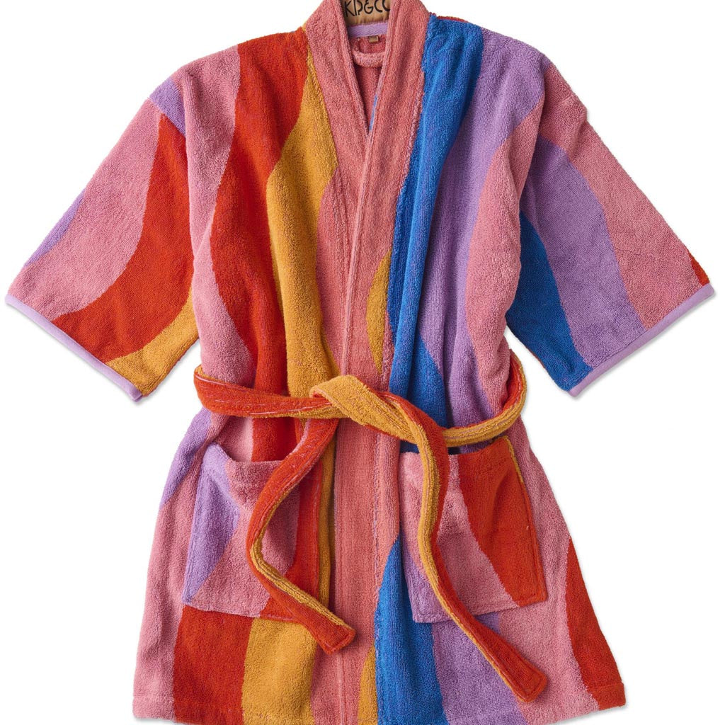 The image is of a children's robe made from terry cloth material. The robe features a colorful and playful design with a surfing theme. It includes various vibrant patterns and illustrations, such as surfboards, waves, and beach-related motifs. The robe has a hood, long sleeves, and a belt for tying around the waist, providing a cozy and comfortable fit for kids. The overall look is fun and suitable for beach or bath time.