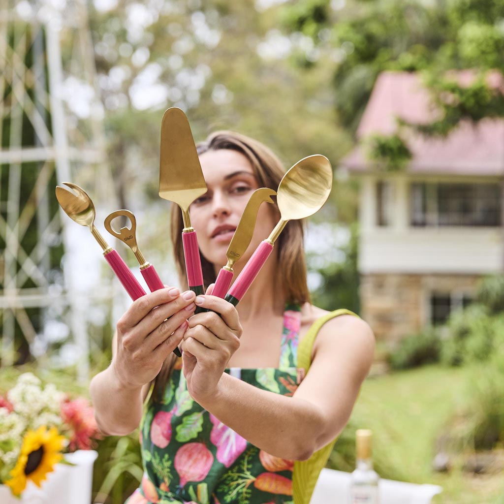 The image shows a set of salad servers, which typically includes a fork and a spoon designed for serving salads. These particular servers have a unique and artistic design, featuring a colorful and vibrant pattern reminiscent of Tuscan or Mediterranean styles. The handles are likely made of a durable material, possibly wood or metal, and are adorned with intricate, multicolored designs that add a touch of elegance and flair. The serving ends are polished and functional, suitable for tossing and serving sala