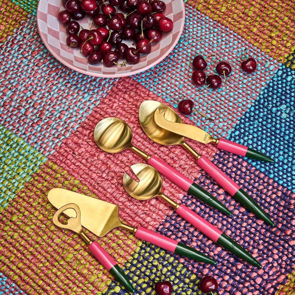 The image shows a set of salad servers, which typically includes a fork and a spoon designed for serving salads. These particular servers have a unique and artistic design, featuring a colorful and vibrant pattern reminiscent of Tuscan or Mediterranean styles. The handles are likely made of a durable material, possibly wood or metal, and are adorned with intricate designs or motifs that give them a decorative and stylish appearance. The serving ends are functional and designed to easily scoop and serve sala