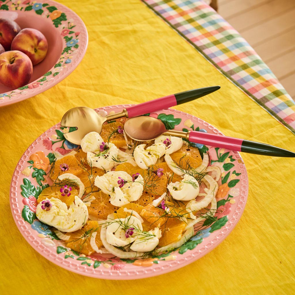 The image shows a set of salad servers, which typically includes a fork and a spoon designed for serving salads. These particular servers have a unique and artistic design, with handles that feature a colorful, abstract pattern reminiscent of a Tuscan landscape. The colors are warm and earthy, with shades of orange, yellow, and green, evoking a sense of Mediterranean style. The servers are likely made of a durable material suitable for kitchen use, and their design suggests they are both functional and deco