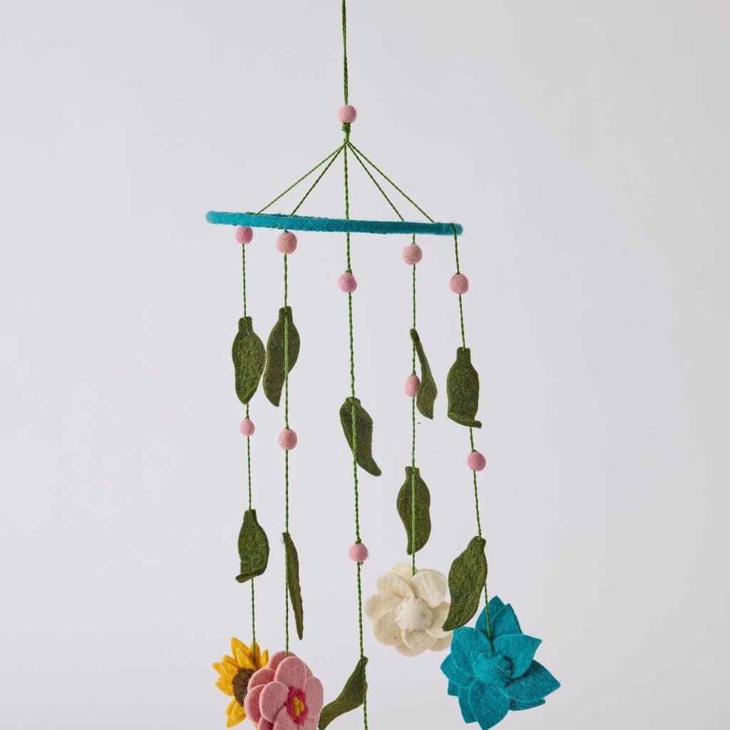 Little Flowers felted wool mobile on a grey background