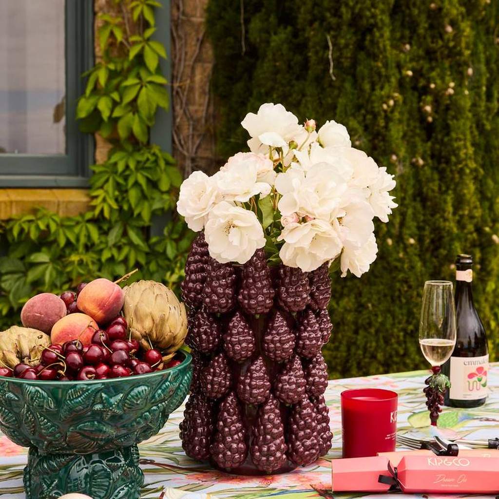 Merlot vase with white roses on a garden table