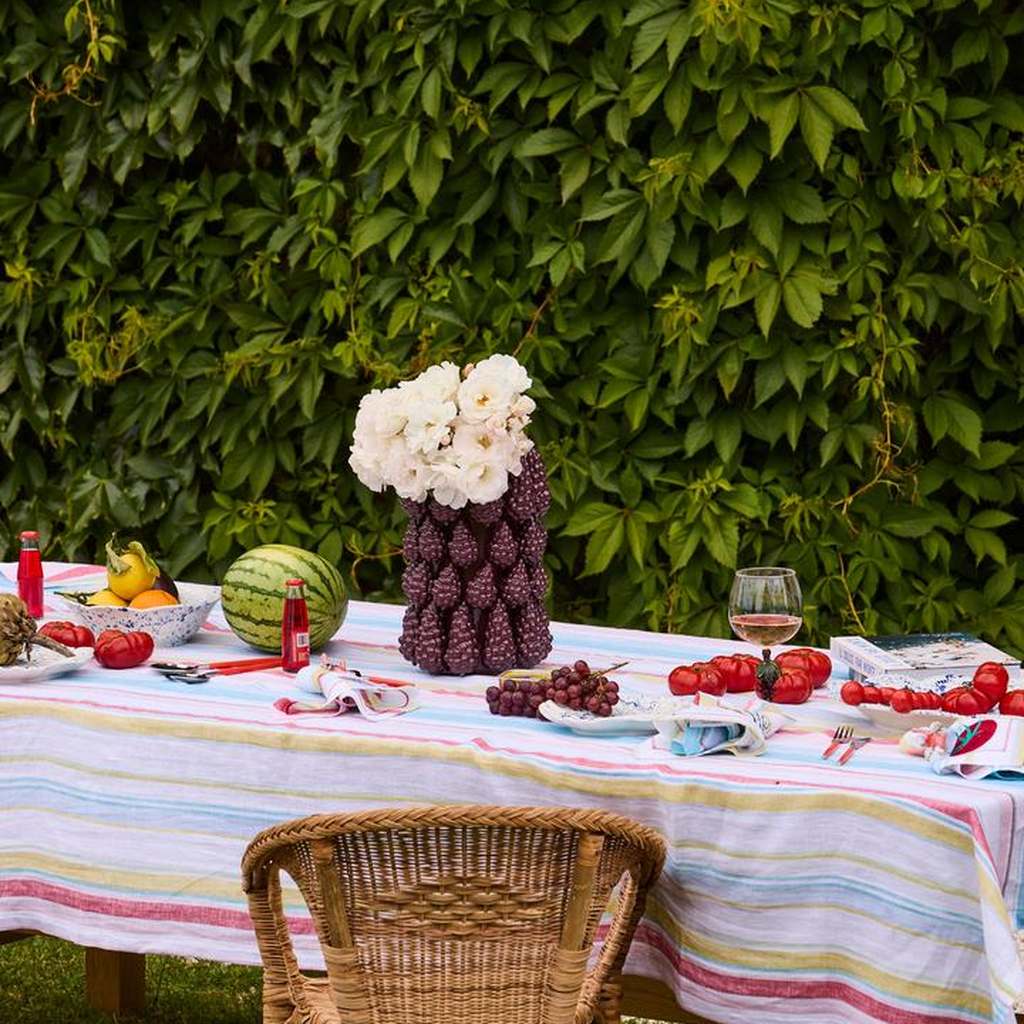 Merlot vase on a table with a striped tablecloth