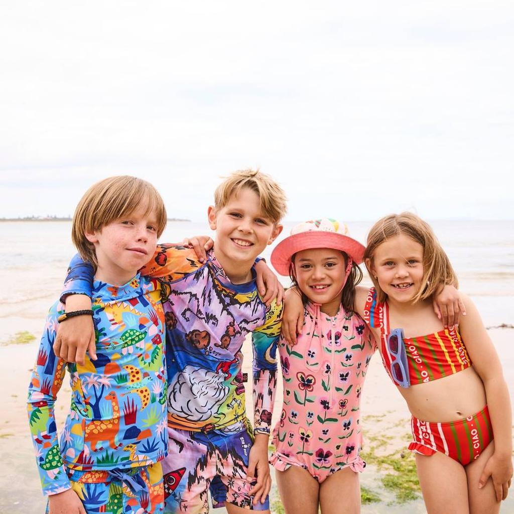 Four kids on the beach in Kip & Co swimwear