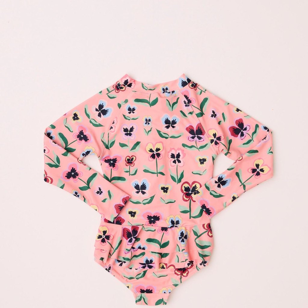 Pretty Pansy long sleeve bathers laid flat on pink