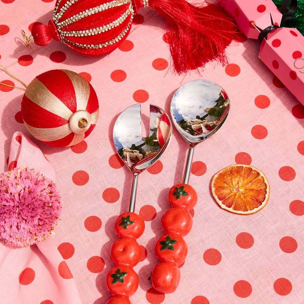 Tomato salad servers on a pink polka dot cloth