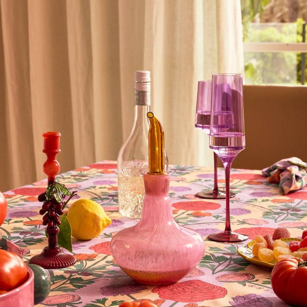 Both Under The Vine candlesticks on a set table with wine and lemons