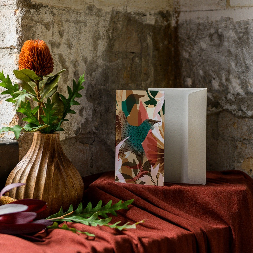 FLOX Tūī Whenua greeting card styled on a shelf