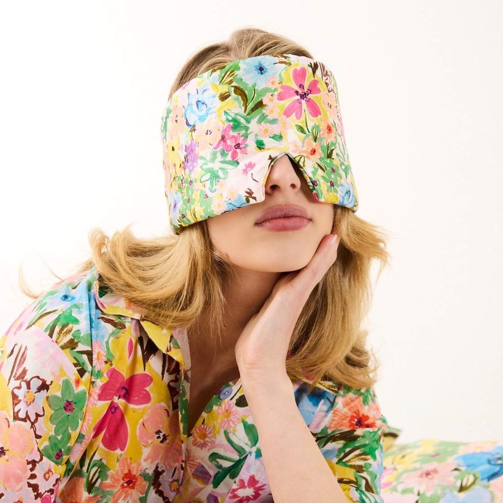 Woman in floral pyjamas wearing the Alfresco eye mask