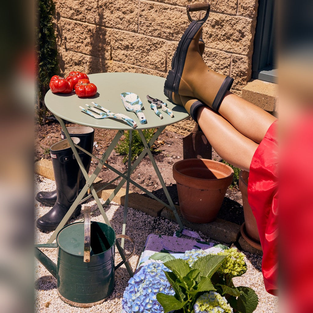 Kip & Co Hydrangea Blue Garden Tools and Gloves Set on a garden table