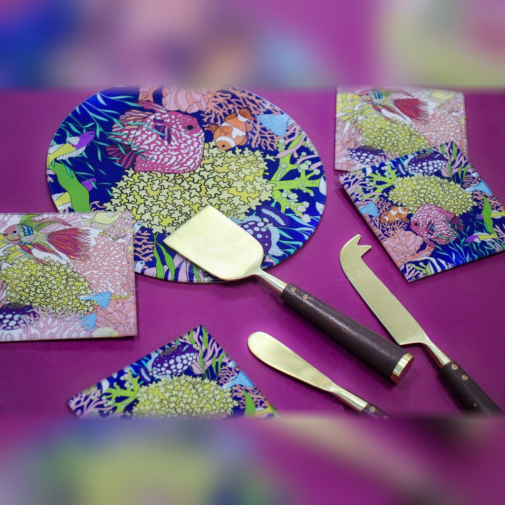 Reef crab glass coasters on a table with cheese knives