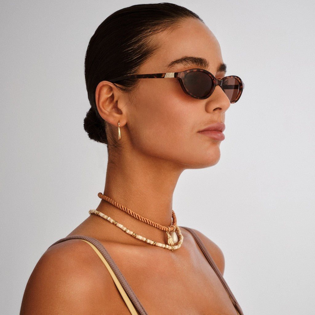Model wearing Le Specs Duskfall Tort sunglasses, side view