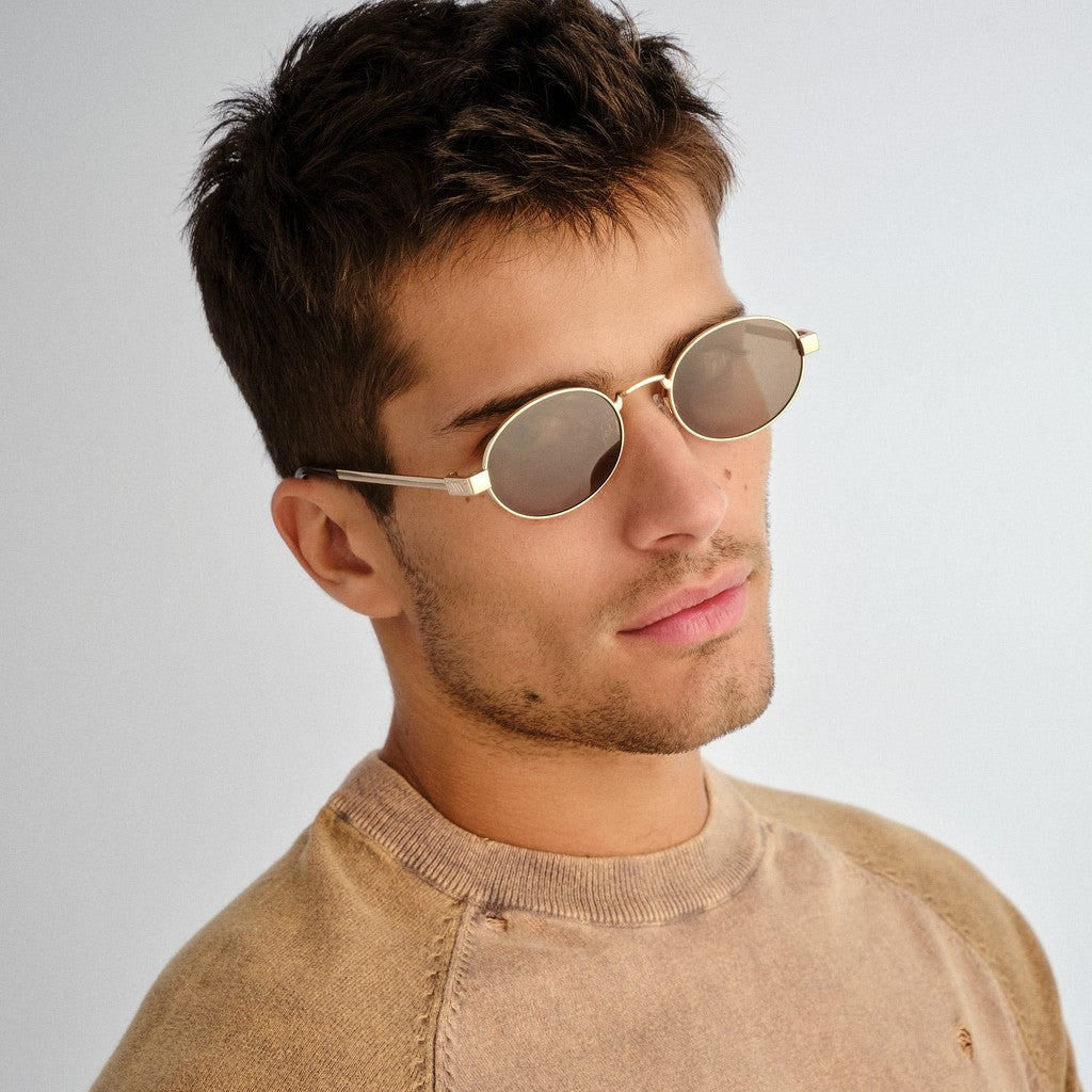 Model wearing Le Specs Poseidon Deux Polarised Gold sunglasses, side view