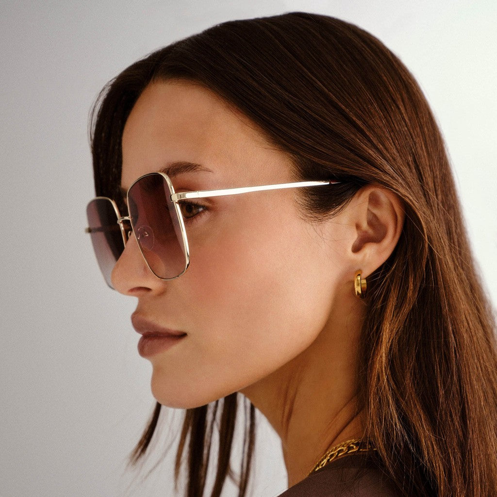 Model wearing Le Specs The Cherished Gold sunglasses, side view