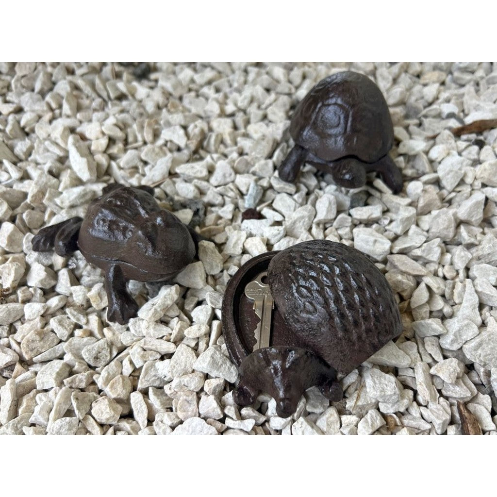 Cast iron key keepers sitting in garden gravel