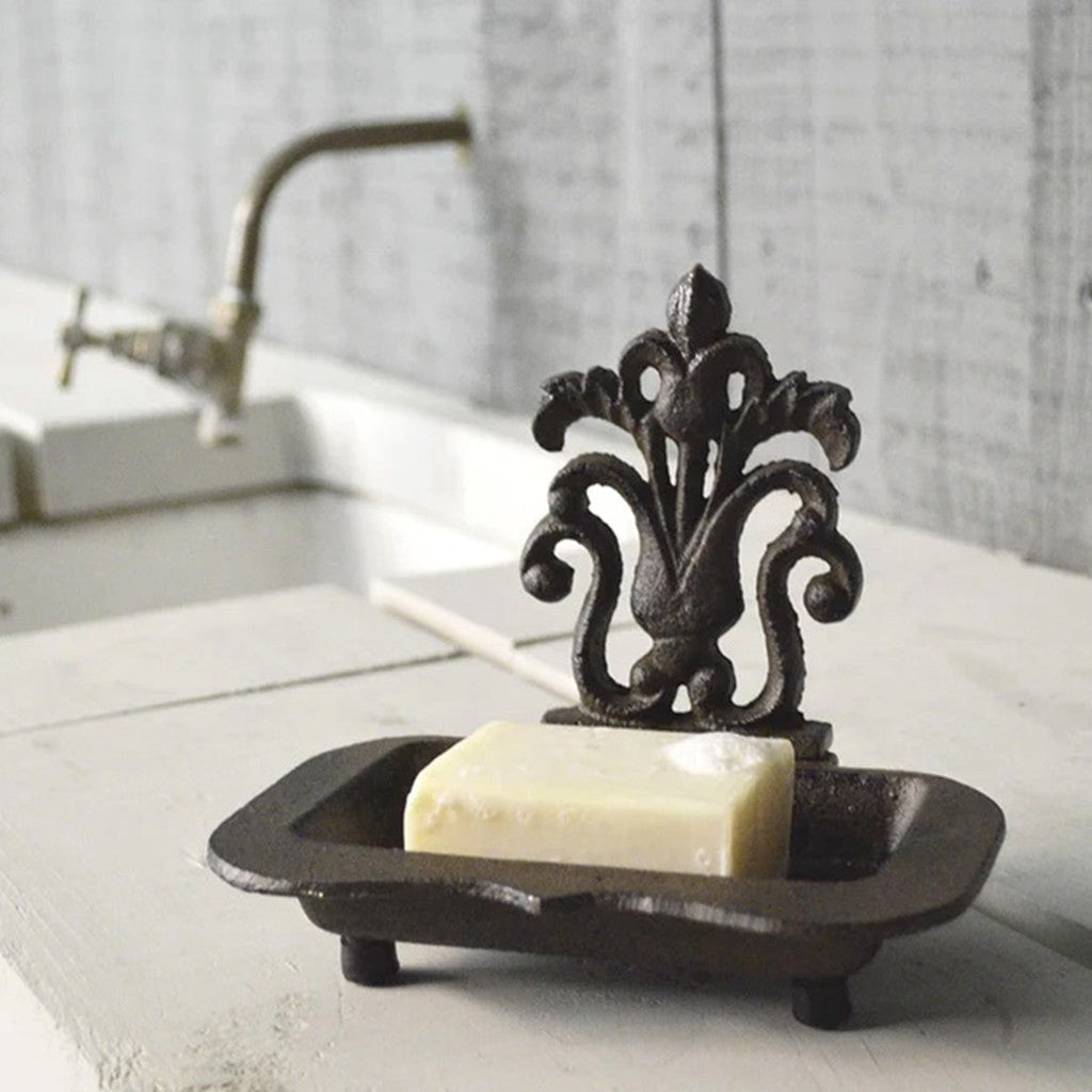 Cast iron soap dish holding a soap bar beside a basin