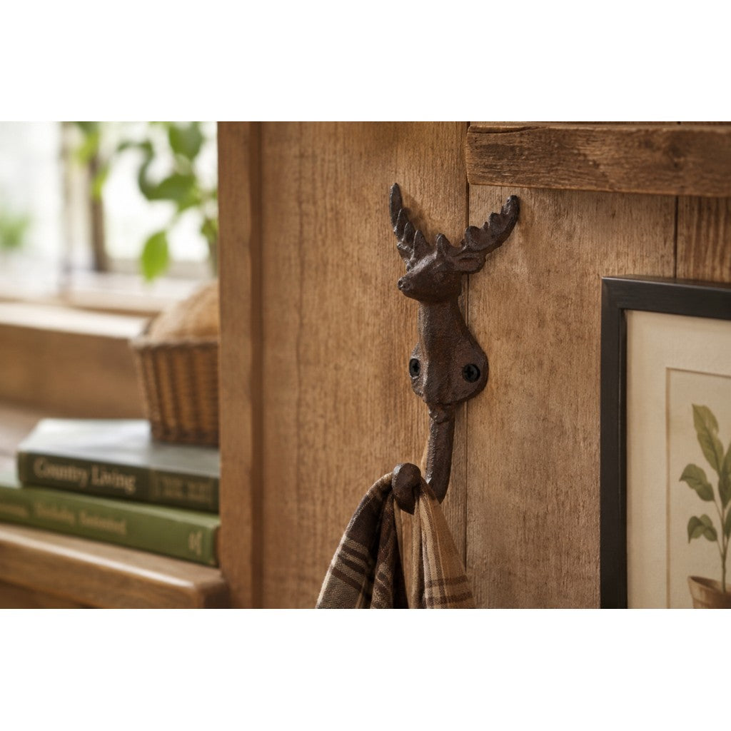 Cast iron deer hook mounted on a timber wall