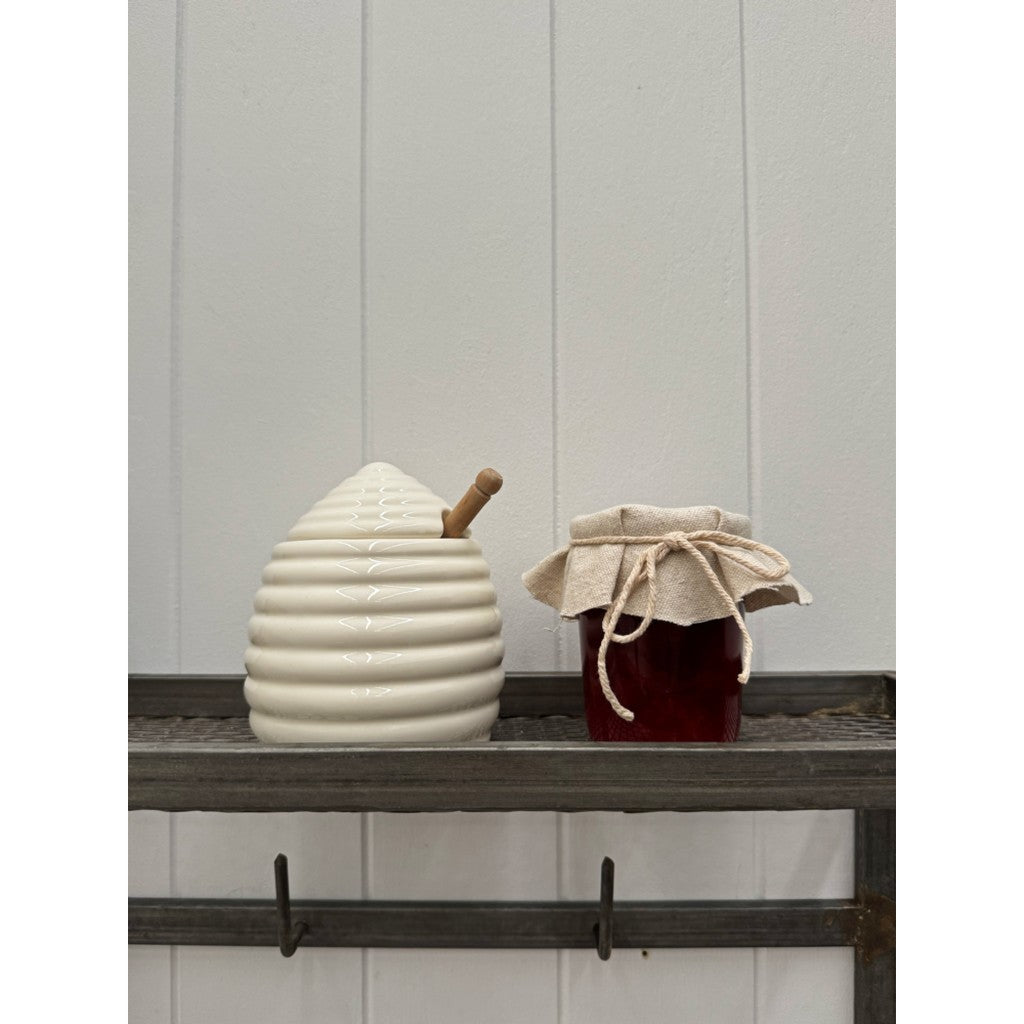 Ceramic honey pot on a shelf
