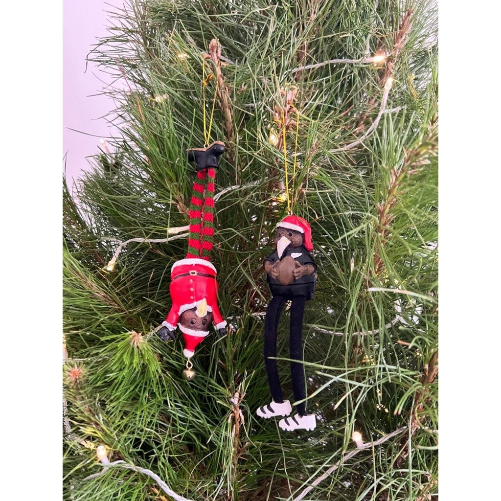 Kiwi rugby player ornament hanging in pine branches