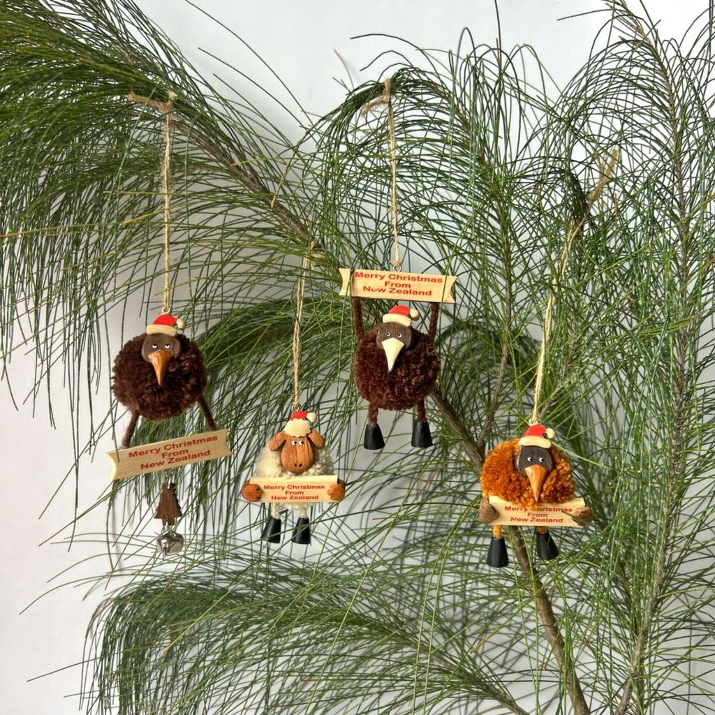 Pompom kiwi ornaments hanging in pine branches