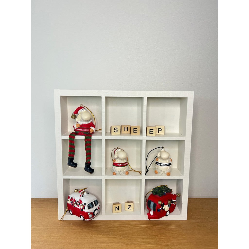 Kiwiana Christmas ornaments displayed in a white shelf unit