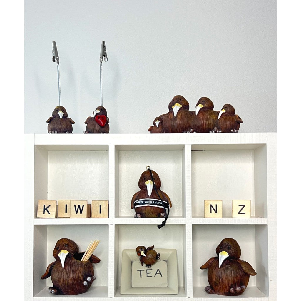 Kiwi figurines displayed in a shelf unit