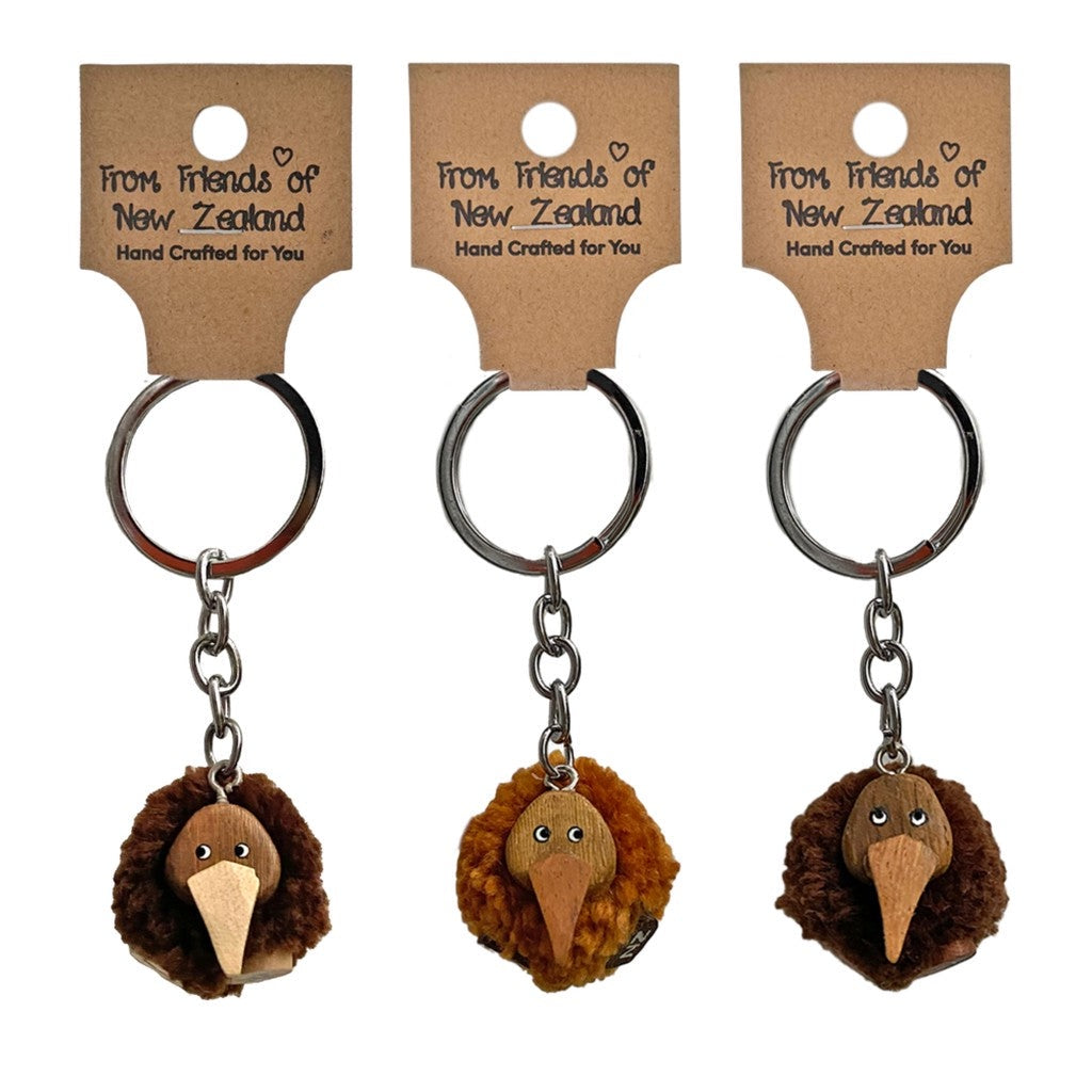 Three pompom kiwi keyrings on their gift cards