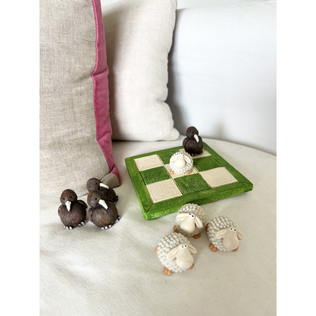 Kiwi and sheep tic tac toe game on a couch