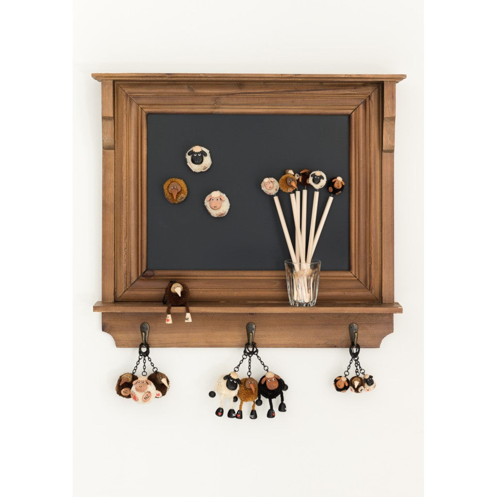 Pompom sheep magnets on a chalkboard noticeboard