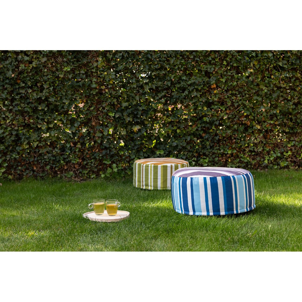 Blue and green striped pouffes on a lawn