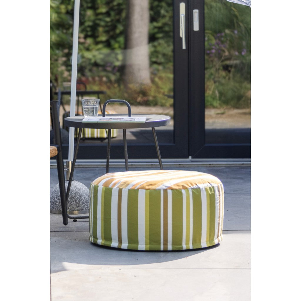 Green striped pouffe on a covered patio