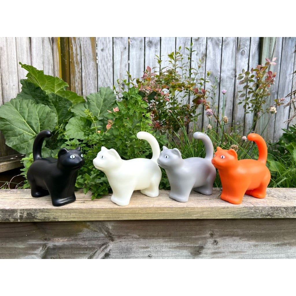Row of cat watering cans in the garden