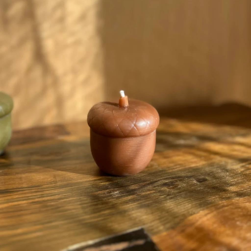 A jar of The Authentic Honey Co. Acorn Amber honey with a golden-brown hue, set against a plain white background. The label on the jar features elegant typography and a minimalist design, highlighting the brand name and product type. The honey inside appears rich and viscous, suggesting a high-quality, natural product.