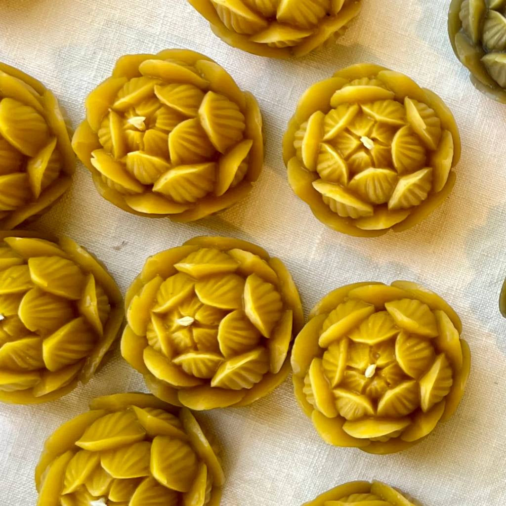 A jar of The Authentic Honey Co. Mini Lotus Natural Honey with a minimalist label design, featuring a lotus flower illustration. The jar is placed on a light-colored surface, highlighting the golden hue of the honey inside.
