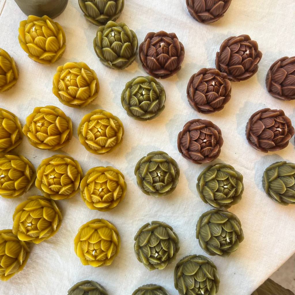 A beautifully arranged set of honey products from The Authentic Honey Co., featuring a mini lotus design. The set includes various jars of honey, each with a distinct label, elegantly displayed on a wooden surface. The packaging is adorned with lotus-themed artwork, emphasizing a natural and authentic aesthetic.